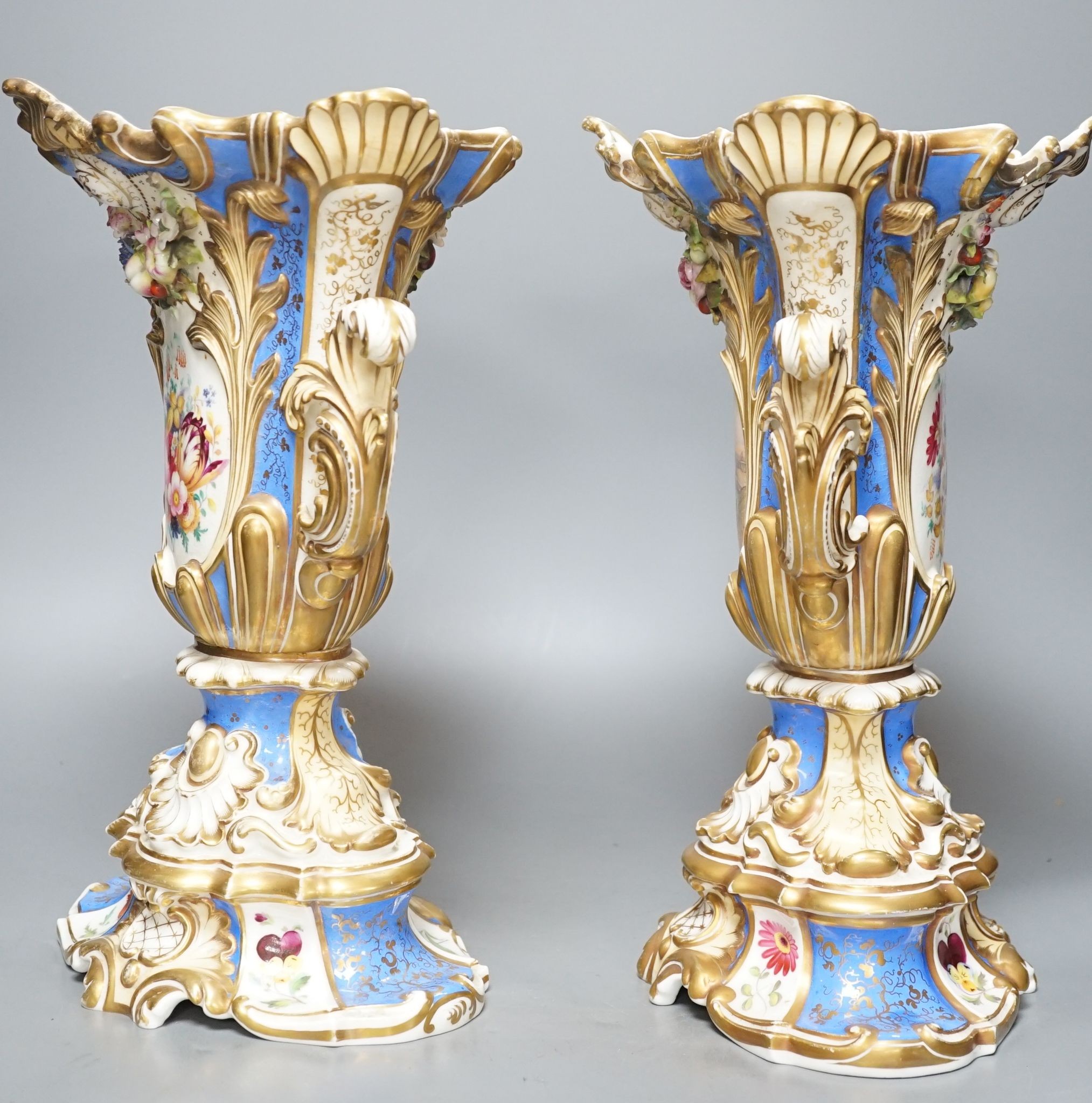 A large pair of 19th century Grainger & Co. vases with scenes of Worcester and Malvern on a blue ground, 34 cms high.